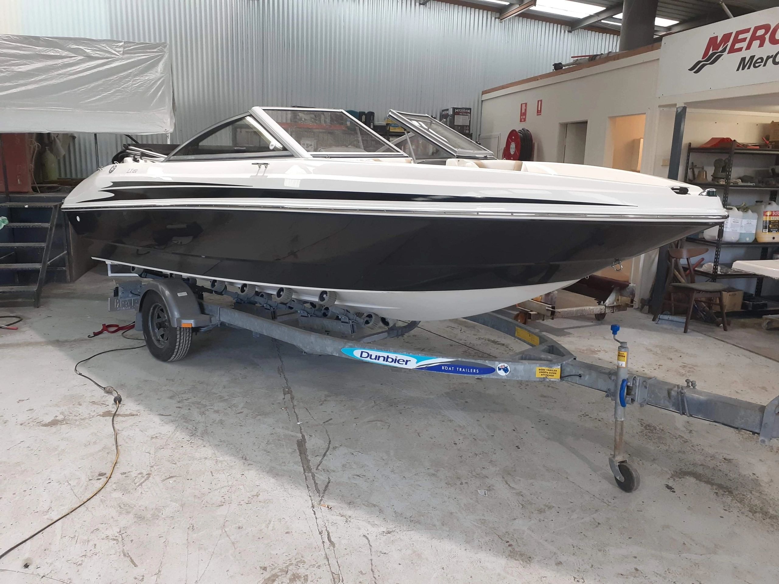 White speedboat on Dunbier trailer warehouse