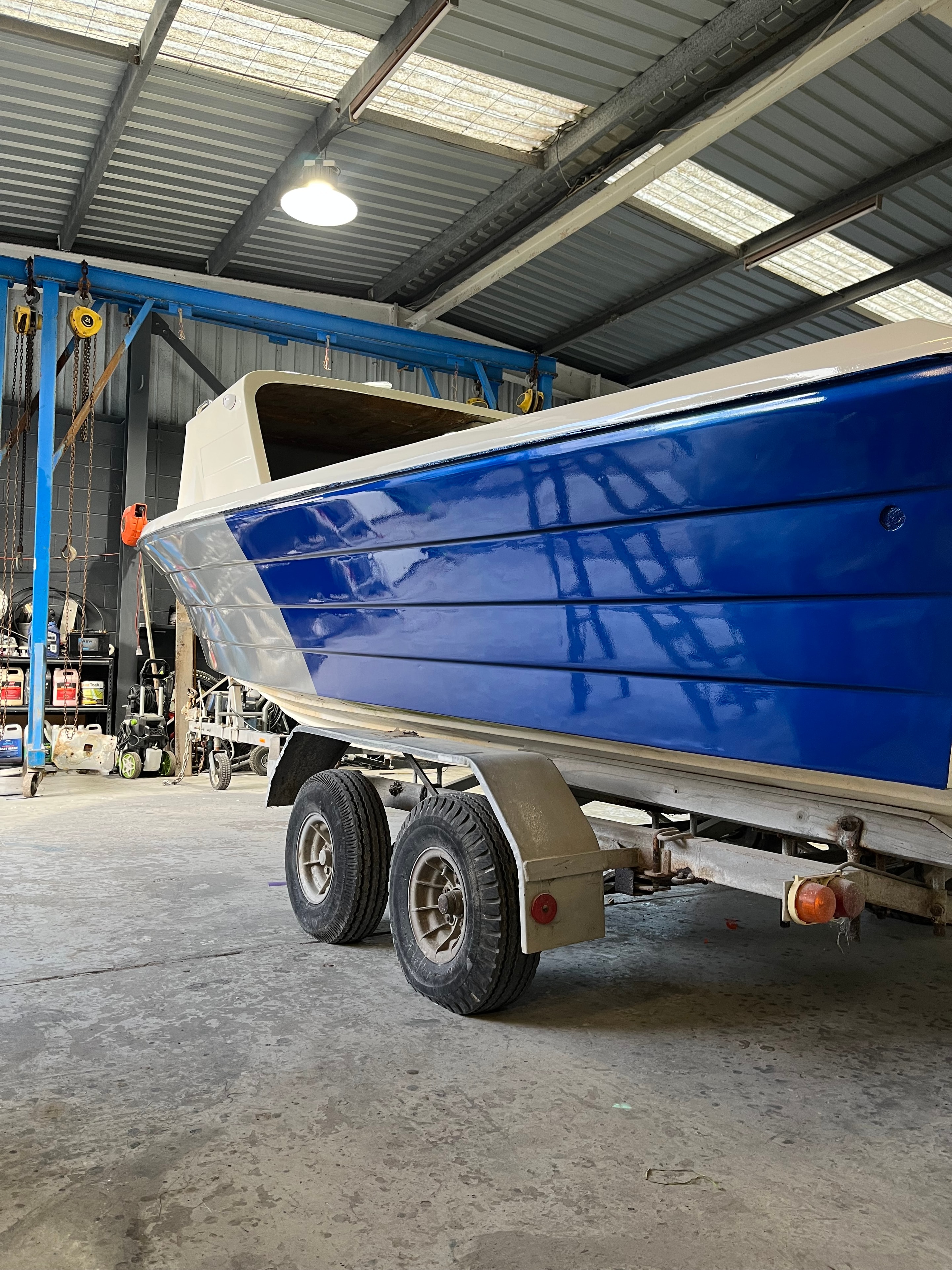 Blue speedboat on trailer warehouse