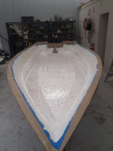 Boat hull under construction in workshop