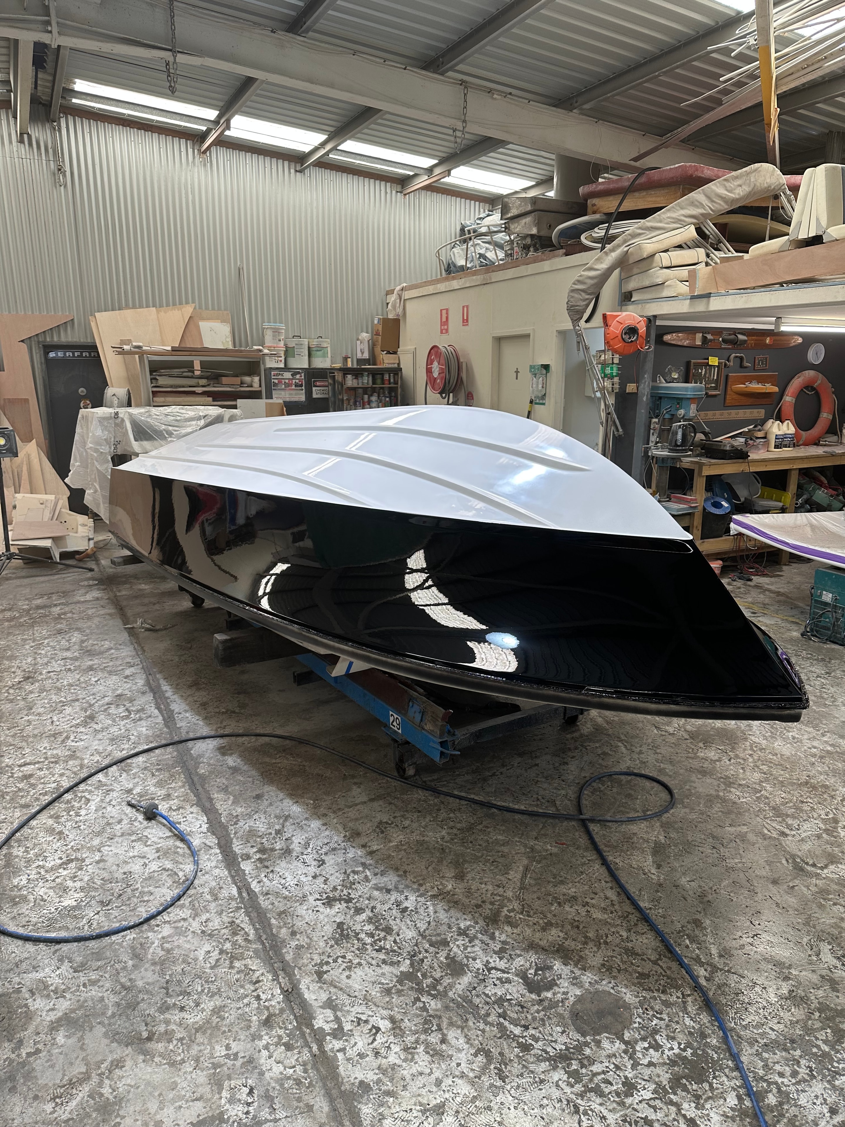 Black and white hull respray in workshop