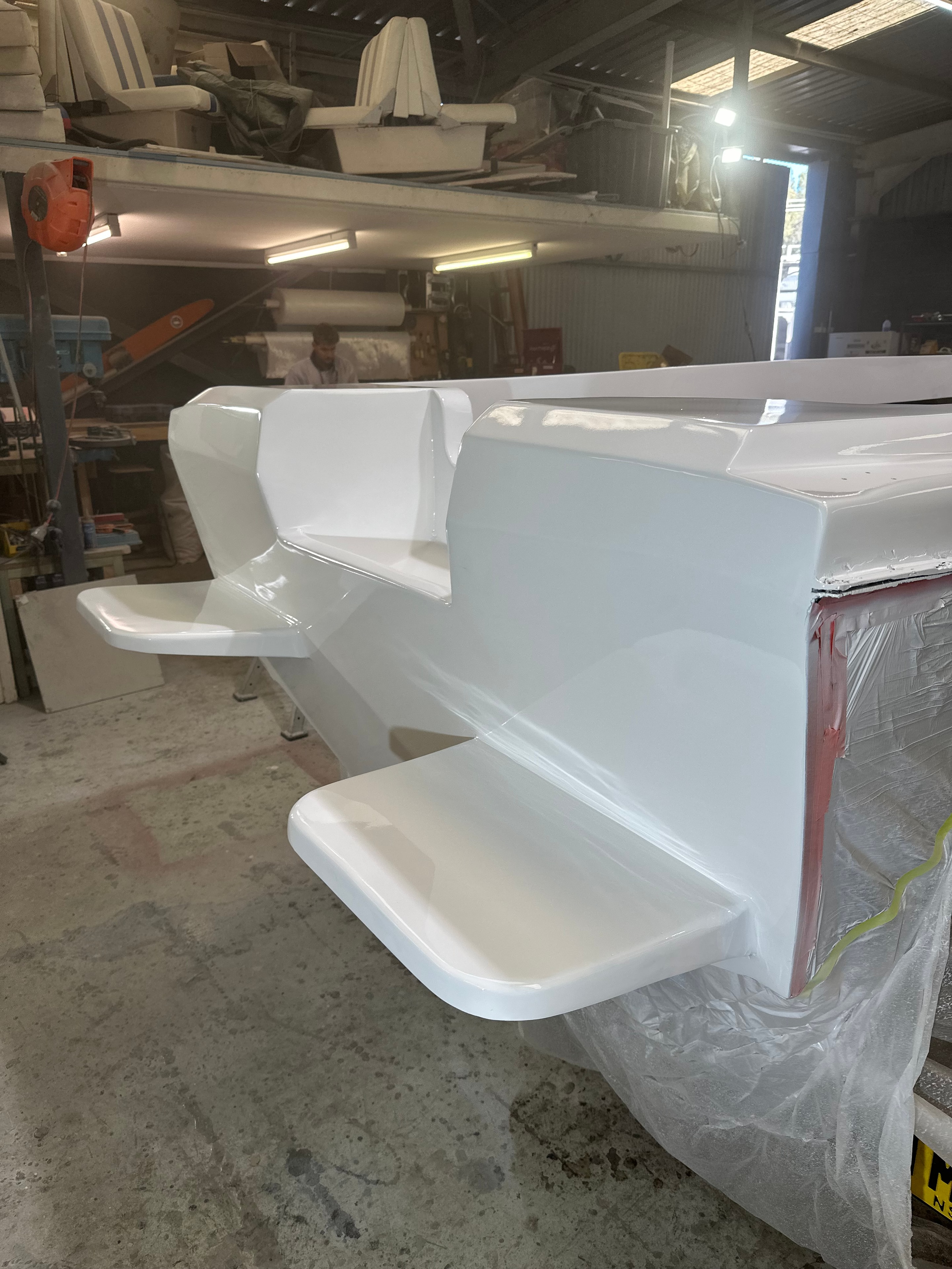 Finished white gelcoat cabinetry components ready for fitting