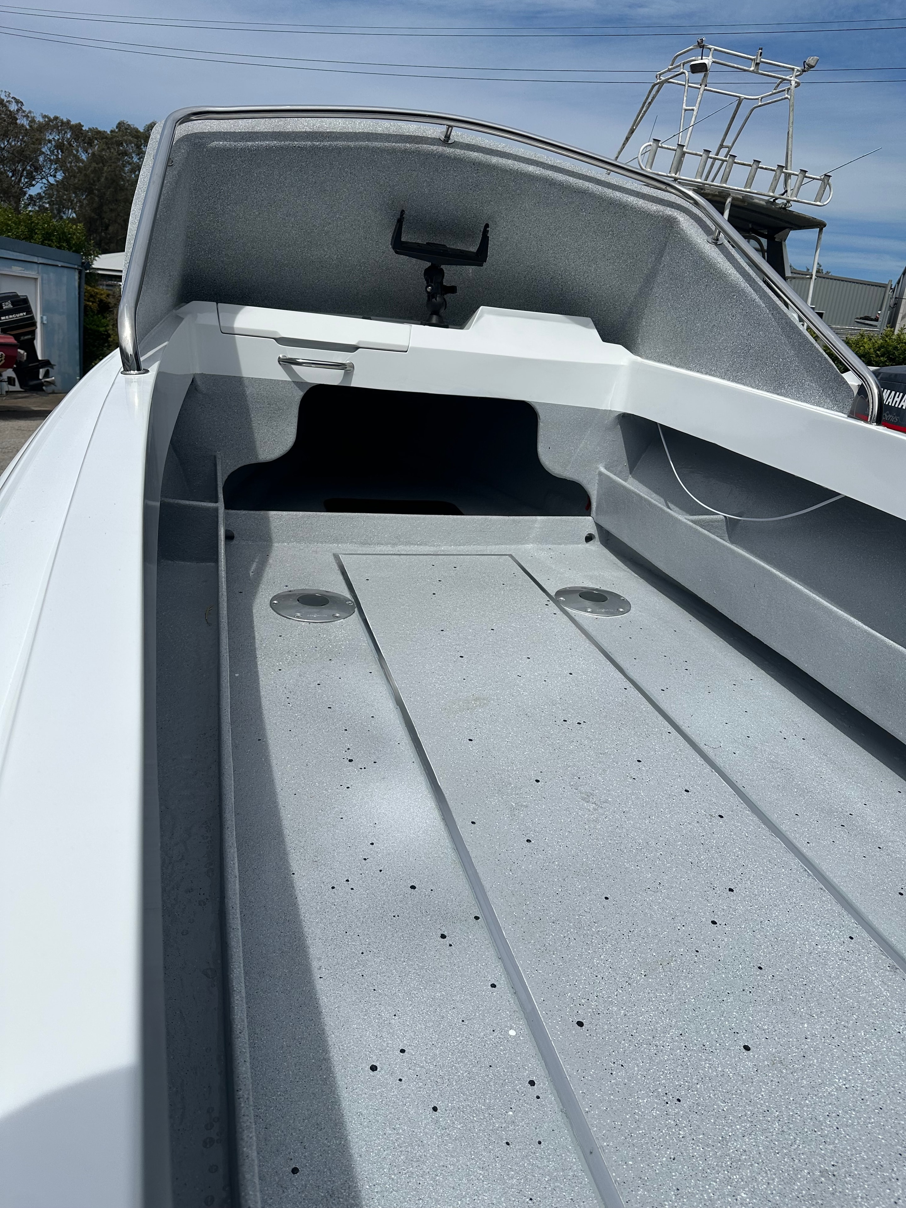 Finished boat deck with grey non-slip gelcoat and white hull