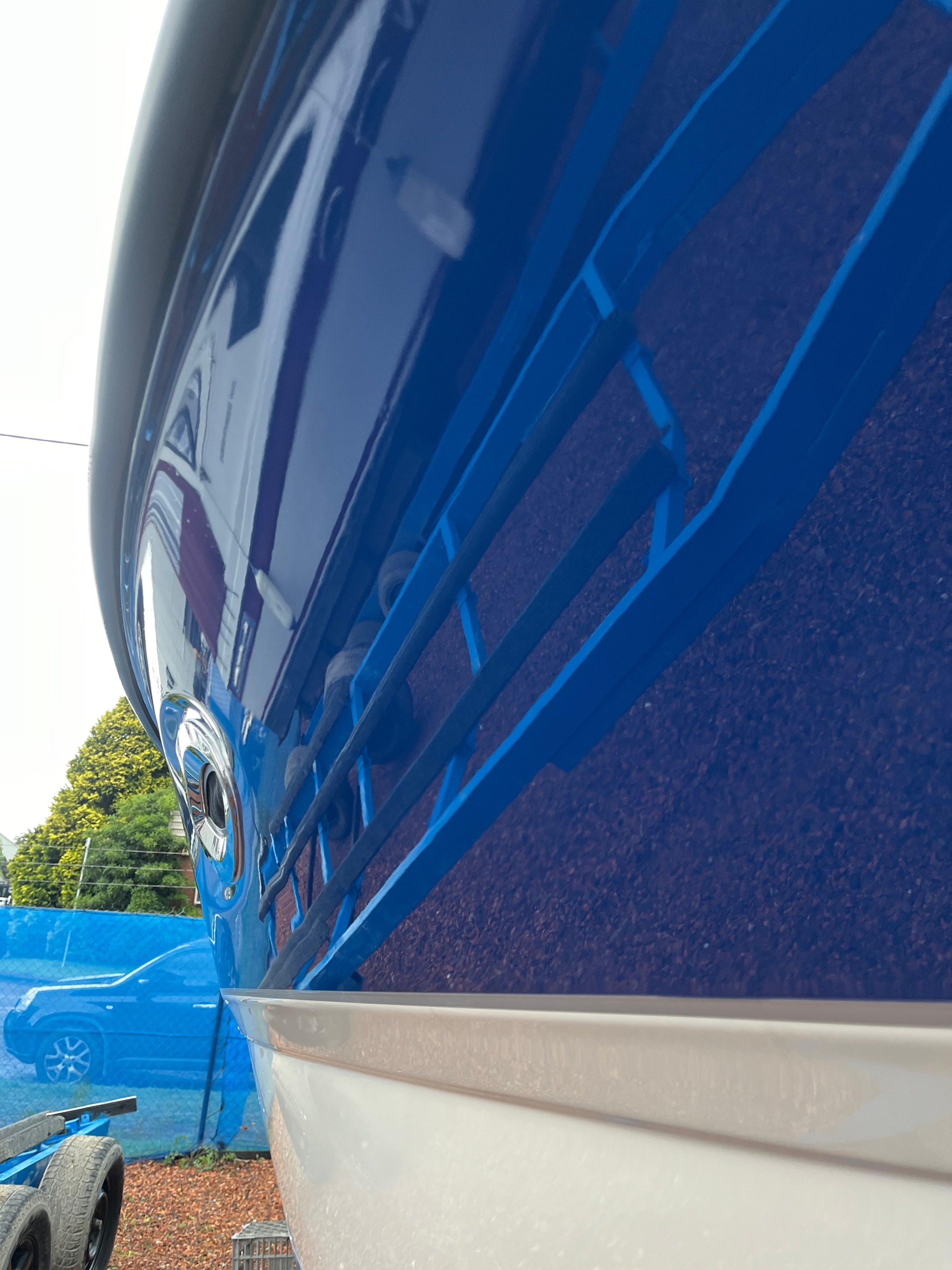 Deep blue gelcoat hull respray finished result
